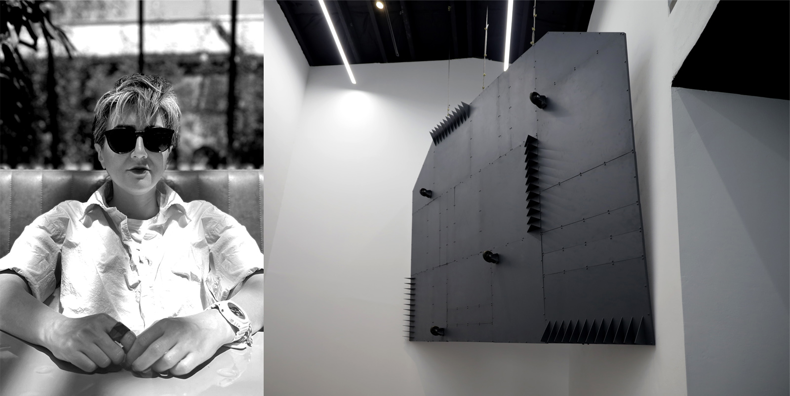 Black-and-white diptych. Left: A person with short light hair sits at a booth wearing dark sunglasses, a light button-up shirt, and a white wristwatch, with hands resting on a reflective table in front of a large window. Right: A large, matte-black geometric wall sculpture with layered triangular fins and protruding cylindrical elements is mounted on a white gallery wall beneath linear ceiling lights.